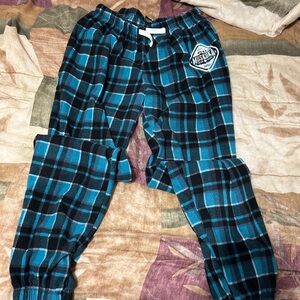 Muskoka bear wear plaid turquoise pants.